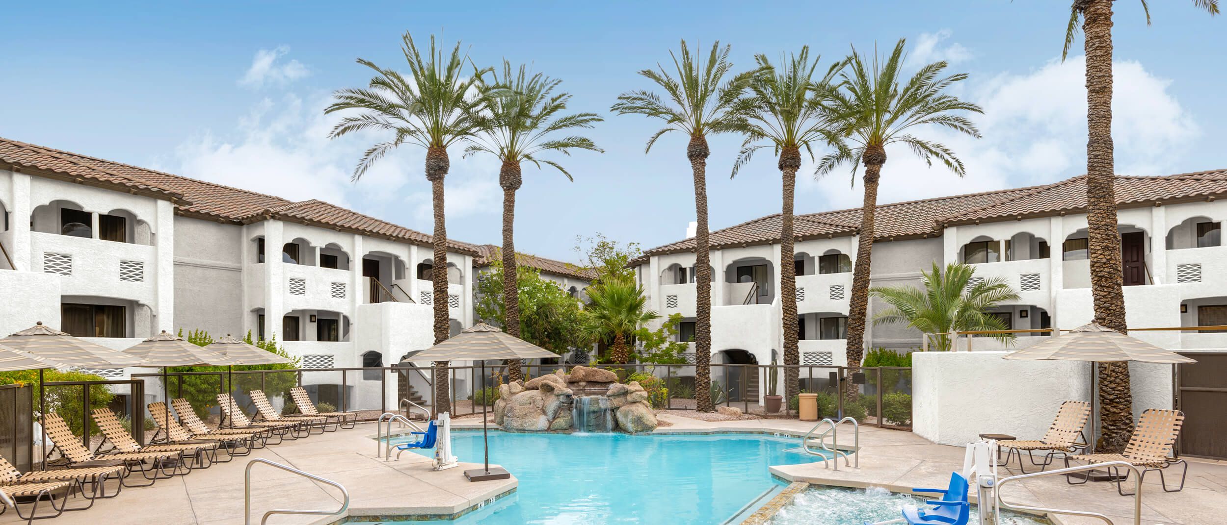 Resort pool surrounded by palm trees